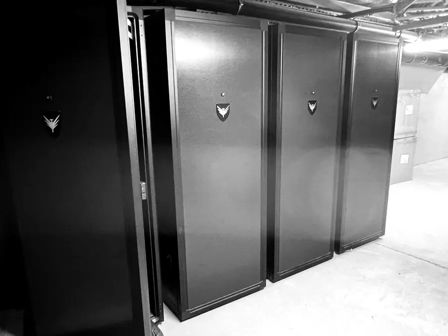 Velohawk bike lockers with the hawk emblem on black doors in a basement